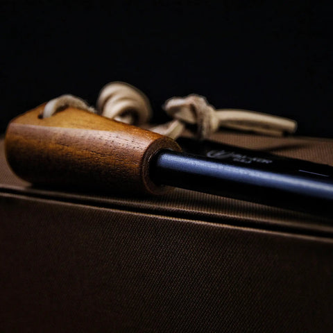 Close-up of Go-To 5.9 Inch Ferro Rod Fire Starter Kit with Wooden Handle and Sheath Waterproof Flint Steel Ignition for camping.