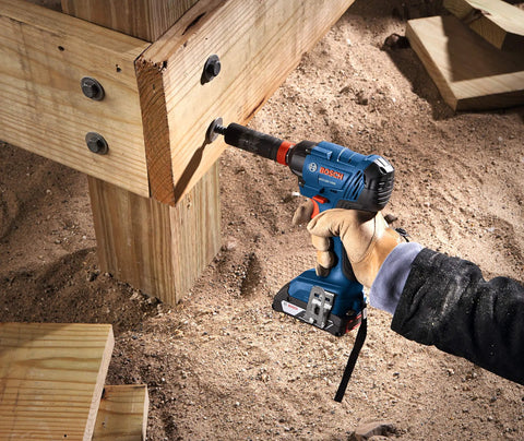 Two-In-One 18V Impact Driver Kit With 1/4 Inch Quick-Change Hex And 1/2 Inch Drive in use on wooden beams outdoors