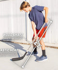 Street Hockey Set With Pop Up Goal Two Wooden Hockey Sticks shown in use outdoors by a young player.
