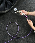 Using Badass Heavy Duty 100 Ft 1/4 Inch Reinforced Polyurethane Air Hose to inflate a tire with gauge.