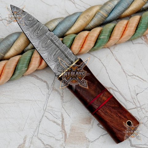 Damascus Steel Fixed Blade Camping Knife With Walnut Wood Handle Brass Bolster And Leather Sheath Included Hand Forged High Carbon Outdoors Gear Built Tough For Survival on marble surface