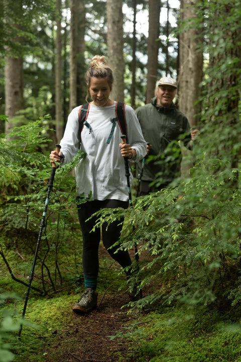 Hikers using Lightweight Aircraft Grade Aluminum Trekking Poles With Extended Down Grip on a wooded trail