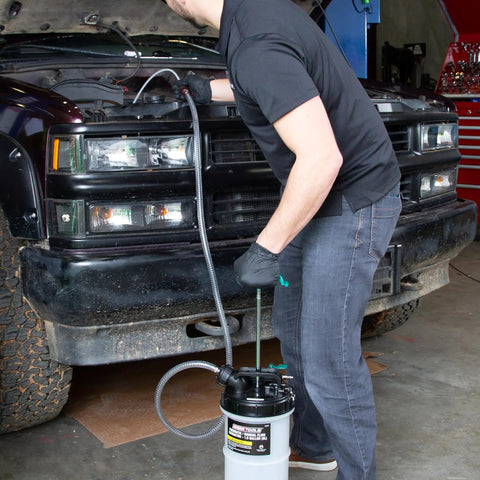 Person using Dual Mode Garage-Grade Fluid Extractor Pump 1.5 Gallon For Oil, Coolant, Transmission, And Power Steering with 5-ft hose