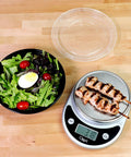 Salad and grilled skewers beside 30 Pack Meal Prep Bowls With Lids, 28 Oz Containers For Soup And Salad, BPA Free