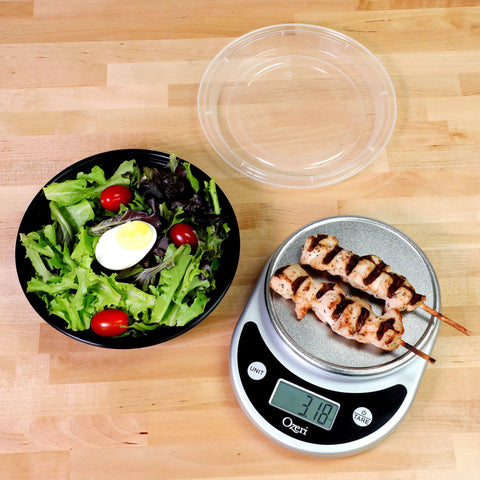 Salad and grilled skewers beside 30 Pack Meal Prep Bowls With Lids, 28 Oz Containers For Soup And Salad, BPA Free