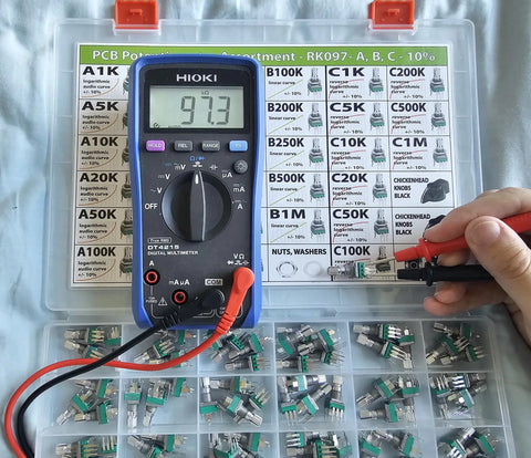 Vertical PCB Mount Potentiometer Kit, 100 Pieces, 9mm Pot, 15mm Shaft, 10 Percent Tolerance used with a multimeter.