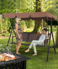 Three Seat Outdoor Porch Swing With Adjustable Canopy, Armrests And Included Stand in a backyard setting with people relaxing.