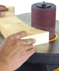 Using Powerful 3.5 Amp Oscillating Spindle Sander With 58 OPM At 2000 RPM to shape wood on work table.
