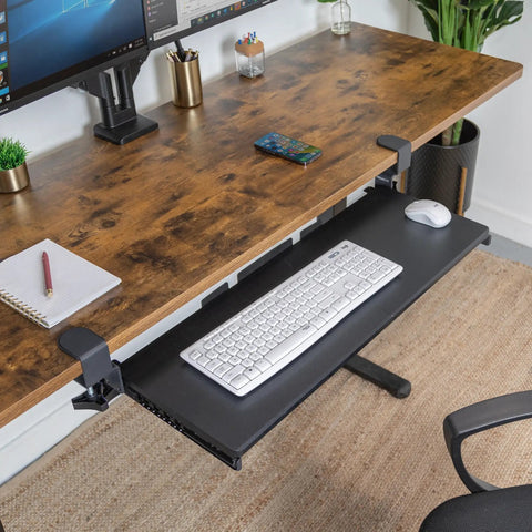 Under Desk Keyboard Tray 30 Inch Extra Wide Slide Out Drawer No Drill Clamp Mount Holds 11 Lbs Fits Desks Up To 1.77 Inches Thick Reclaim Desk Space And Upgrade Your Workstation under a wooden desk with keyboard and mouse
