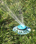 Sprout Metal 8 Pattern Sprinkler With Quick Connect Adapter Amazon Bundle In Gooseberry Green on grass, water spraying.