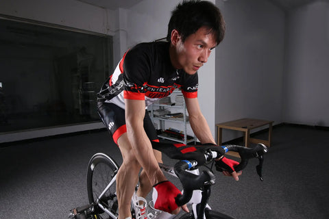 Cyclist using Indoor Bike Trainer Sweat Net Guard Dual Layer Absorbing Catcher That Keeps Your Frame And Floor Dry Stops Sweat