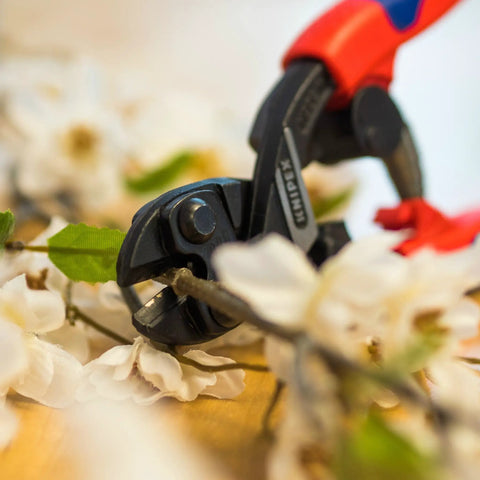 High Leverage CoBolt Cutter With Notch And Spring For No Sweat, Effortless Cuts trimming branch with white flowers