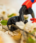 Beefy High Leverage Cobalt Cutters With Comfort Grip And Opening Lock Spring Assist snipping through branches in close view.