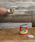 A person applying Liquid Rubber Coating Sealant For Roofs Basements RVs And Trailers Waterproof Flexible Breathable UV Resistant Goes On Smooth And Fast To Seal Water Air And Moisture Clear 32 Oz with a brush.