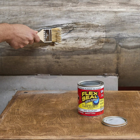 A person applying Liquid Rubber Coating Sealant For Roofs Basements RVs And Trailers Waterproof Flexible Breathable UV Resistant Goes On Smooth And Fast To Seal Water Air And Moisture Clear 32 Oz with a brush.