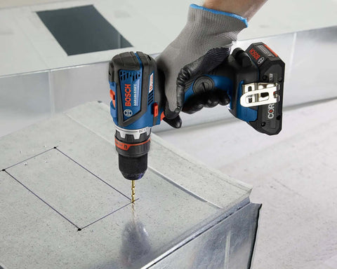 Compact 18V Cordless Drill Driver With Brushless Motor And Rugged Locking Chuck Supporting 5In1 Flexiclick Quick Swap System Paired With A Badass 4Ah Battery Pack drilling into metal surface.