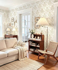 Beige Floral Peel And Stick Wallpaper With Delicate Arched Accents in a cozy living room with a sofa and armchair.