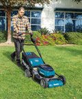 User operating the Top Shelf 21 Inch Cordless Lawn Mower Built Ridiculously Tough With A Badass Brushless Motor And Quad Battery Slots To Handle Big Yards Without Gas Grief Tool Only on a grassy area.