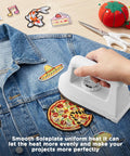 Compact Mini Iron For Clothes, Portable Travel Steam Press Machine For T Shirts And Crafts applying heat to patches on denim.