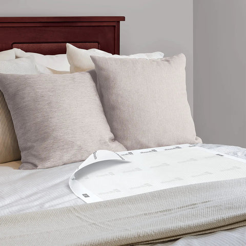 Hospital Grade Quality Built Tough For Heavy Duty Care Super Absorbent Disposable Incontinence Bed Pads 30 By 36 Inch 25 Pack on a bed with pillows.