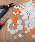 200Pcs White Plastic Gears Module 0.5 For DC Motors RC Cars DIY Models Robots Replacement Kit on wooden surface with tools