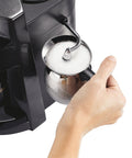 The Real Deal 4 Cup Steam Espresso System With Built In Frothing Arm creating frothed milk in a stainless steel pitcher.