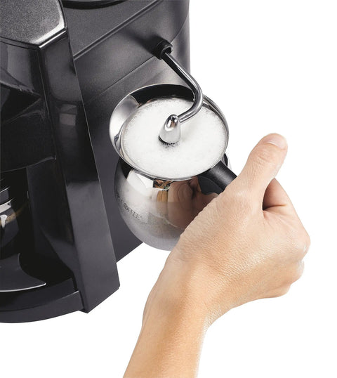 The Real Deal 4 Cup Steam Espresso System With Built In Frothing Arm creating frothed milk in a stainless steel pitcher.