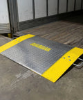 Beefy Aluminum Dock Plate 48 x 60 For Pallet Jacks And Hand Carts, 2900 Lb Capacity on loading dock with yellow curbs