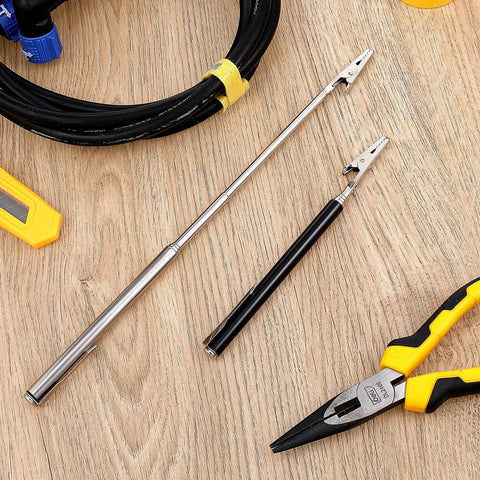 Stainless Steel Alligator Clips Set With Telescopic Wire Clamps And Pen Clip on wooden table next to pliers and cable