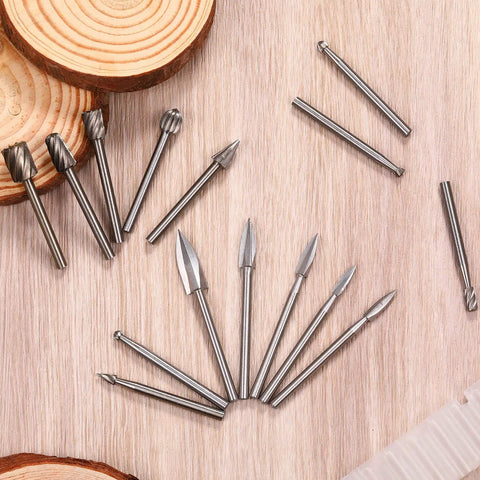 Wood Carving And Engraving Drill Bit Set 15 Piece Kit with engraving bits and HSS carbide rotary burrs on wooden surface.