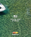 Aerial view of a boat near a dock with text 'Proudly Made in the USA' on clear water background.