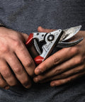 Man holding 8.3 Inch Pruning Shears With Aluminum Handles, Precision Bypass Blade, 1 Inch Cutting Capacity, tool in hands