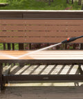 Beastly 2000 Max PSI Electric Powered Pressure Washer With 14.5 Amp Motor cleaning a deck bench with adjustable nozzle