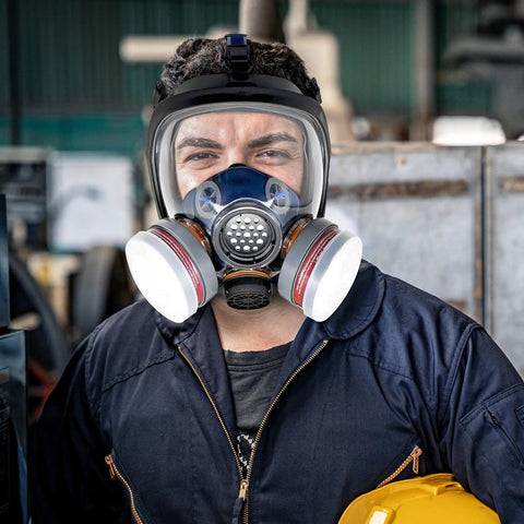Man wearing a Full Face Organic Vapor Respirator With Anti Fog Shield, Protective Eye And Nose Guard, heavy duty lens, dual filters.
