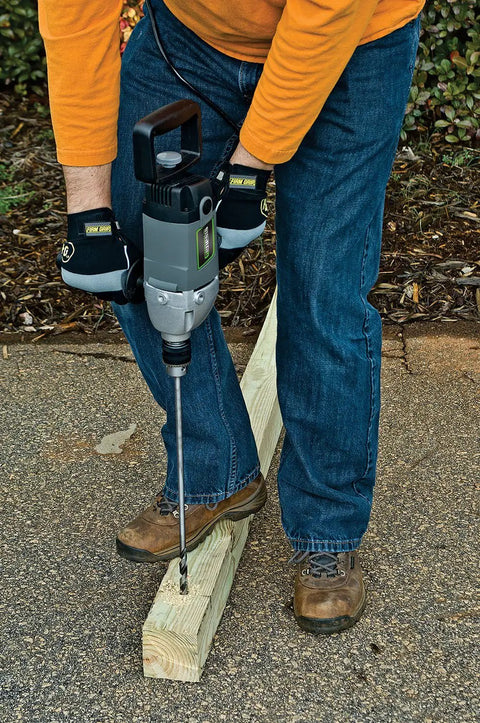 Person using Heavy Duty 9.0 Amp Variable Speed Drill With Lock-On Button Three-Position Auxiliary Handle Two-Position Spade Handle 1/2-In Chuck Chuck Key And 2 Year Warranty Perfect For Mixing Drywall Mud Paint Thin-Set Wood Metal on a wooden beam