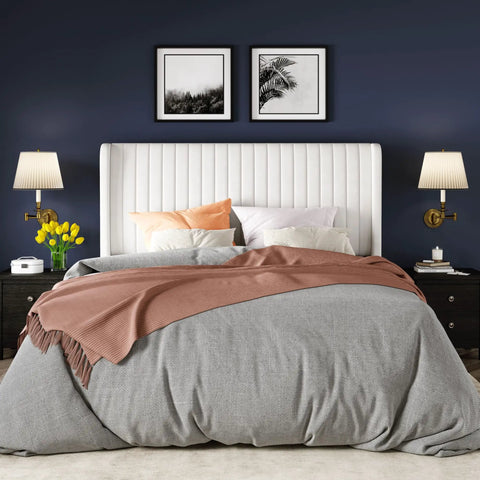 White Queen Velvet Bed Frame With Upholstered Wingback Headboard And Vertical Tufted Design Built On Heavy Duty Metal Base With Wooden Slats For Quick No Box Spring Bedroom Setup That Brings Major Style And Hits Different with gray bedding and decorative pillows.