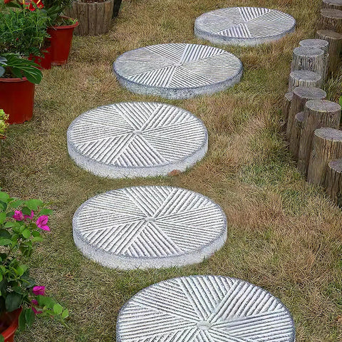 Garden pathway with two round stepping stone molds for concrete pavers, reusable plastic path maker kit for DIY garden paths walkways patios.
