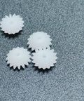Four plastic gears from the Dope Ten Piece Bevel Gear Set 0.5 Module 16 Teeth 1.9mm Bore 2mm Tight Fit for models and projects.