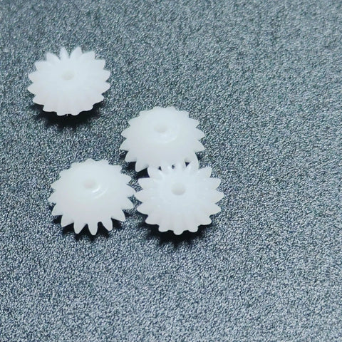 Four plastic gears from the Dope Ten Piece Bevel Gear Set 0.5 Module 16 Teeth 1.9mm Bore 2mm Tight Fit for models and projects.