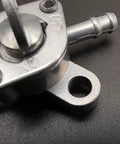 Close-up of Inline Gas Petcock Shut Off Valve for Mini Bikes Dirt Bikes Go Karts ATVs Tao Tao Scooters Fits Three Sixteenth Inch ID Fuel Line And One Quarter Inch Inlet Outlet For 50cc To 125cc Engines And Generators.