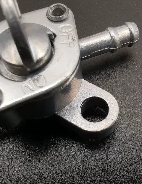 Close-up of Inline Gas Petcock Shut Off Valve for Mini Bikes Dirt Bikes Go Karts ATVs Tao Tao Scooters Fits Three Sixteenth Inch ID Fuel Line And One Quarter Inch Inlet Outlet For 50cc To 125cc Engines And Generators.
