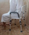 Hercules Series Adjustable Navy Bath And Shower Chair, 300 Pound Capacity, Quick Release Back And Arms in a shower setting