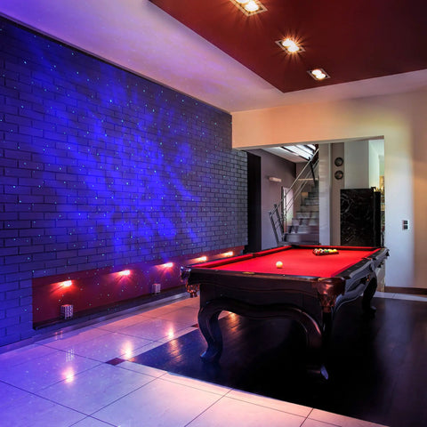 Sky Lite LED Laser Star Projector with green stars and blue nebula clouds illuminating a billiard room for instant atmosphere.