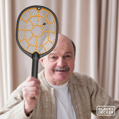 Older man holding Cordless Electric Fly Swatter Racket For Gnats And Mosquitoes Outdoor Indoor Bug Zapper Handheld Battery Powered Pest Control Tool For Home Patio Garden Safe For Humans Fast Easy Bug Busting.