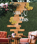 12 Pack 10 By 10 Inch Boxwood Panels Artificial Grass Wall Backdrop with wooden decor, flowers, and Mr & Mrs sign