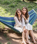 Two women sitting on blue hammock Ultra Lightweight Portable Camping Hammock For Backpacking Beach Patio And Backyard Durable Fabric
