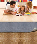 Family enjoying reading on laminate floor with Pro Grade Flooring Underlayment Roll For Laminate Wood And Tile Sound Dampening Padding.