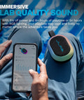 Person using phone next to Portable Bluetooth Speaker Waterproof IP55 With Customizable RGB LED Lights 5W Sound Delivers 8 Plus Hours Playtime