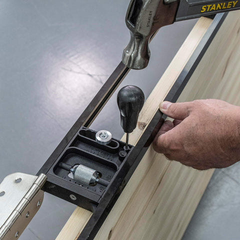 Close-up of Butt Hinge Template Kit with Fully Adjustable Router Jig in use on a wooden door frame for hinge routing