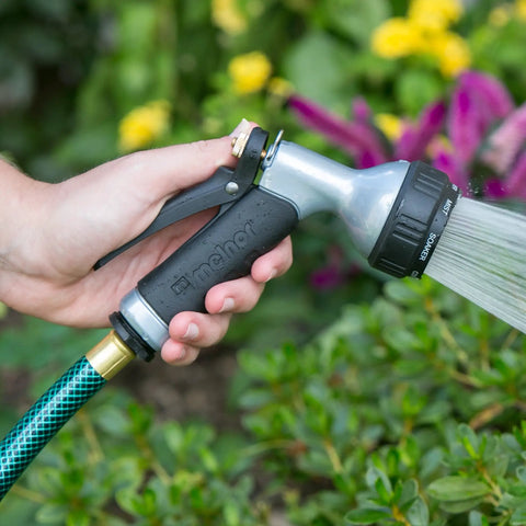 Person using Small Metal Garden Hose Nozzle With Seven Spray Patterns, Easy Grip Handle For Smaller Hands, Durable Metal Construction.